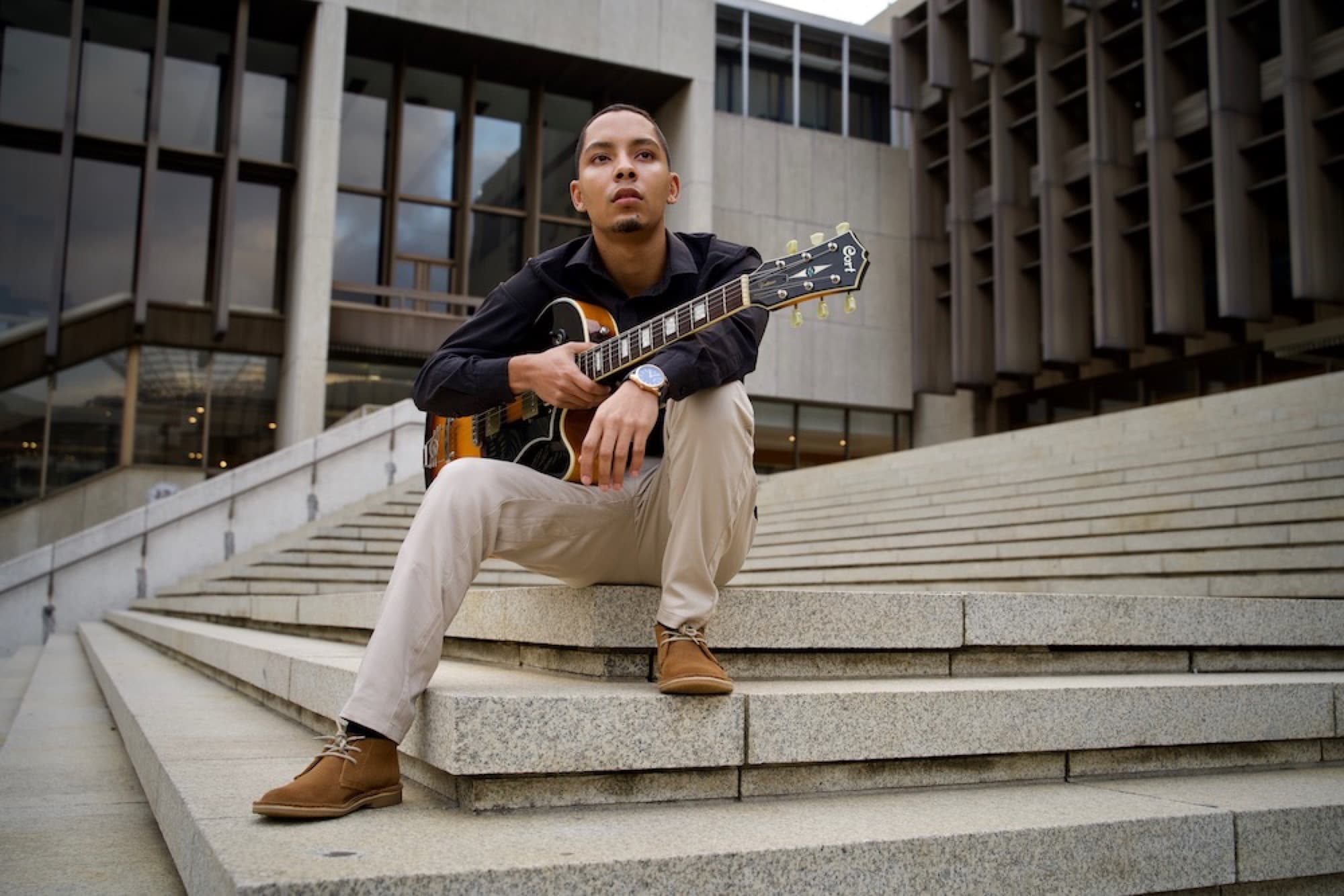 Environmental portrait, guitarist on steps, Cape Town