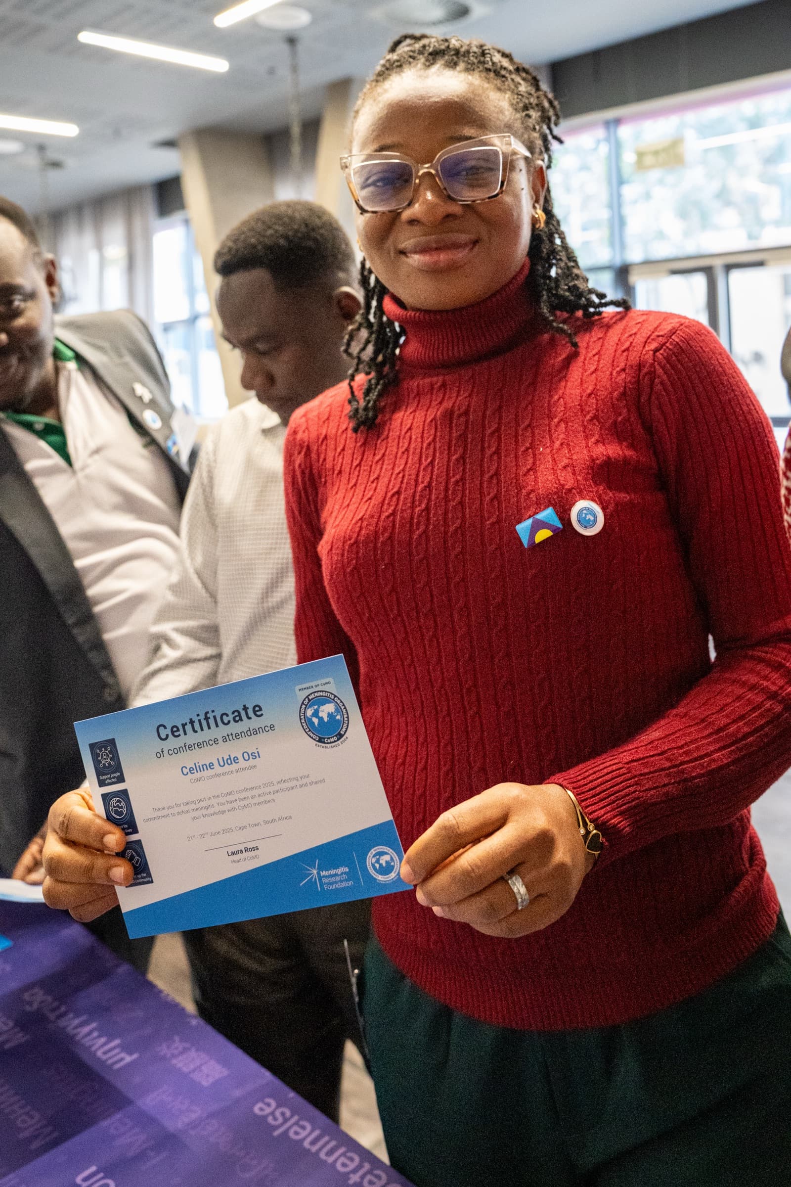 Delegate holding conference attendance certificate, candid portrait, Cape Town