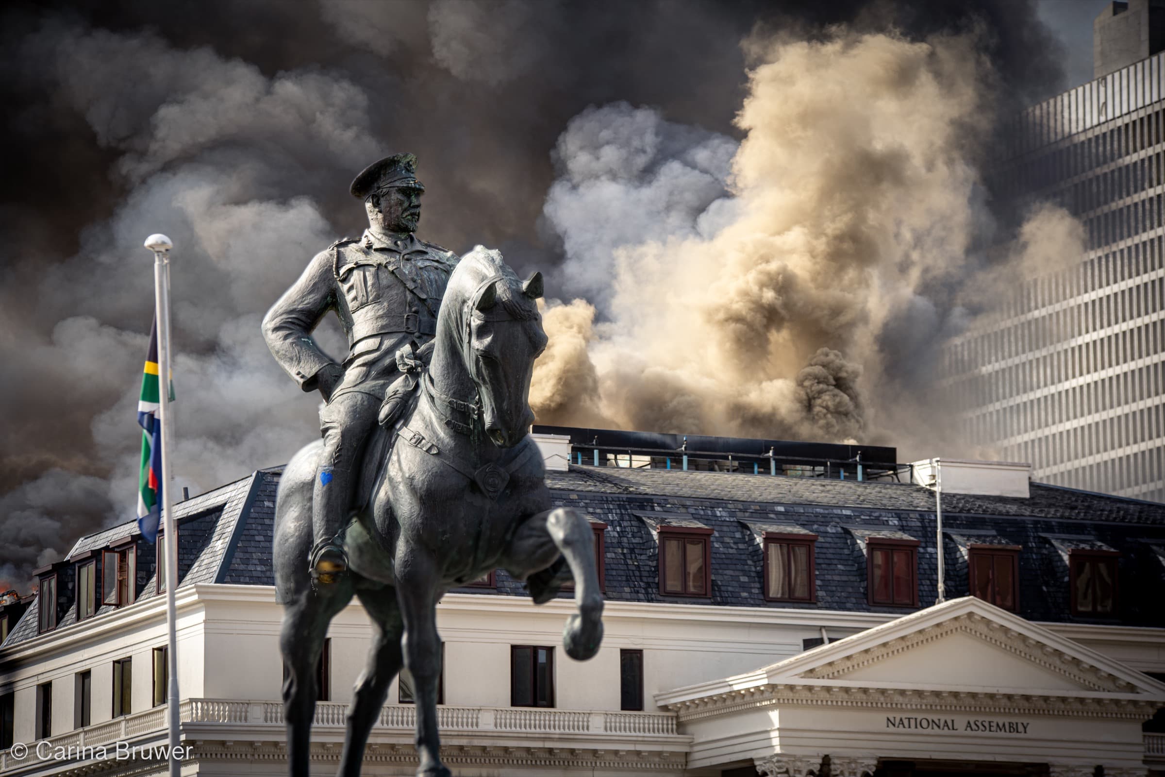 Cape Town Parliament fire, National Assembly ablaze, with statue in foreground