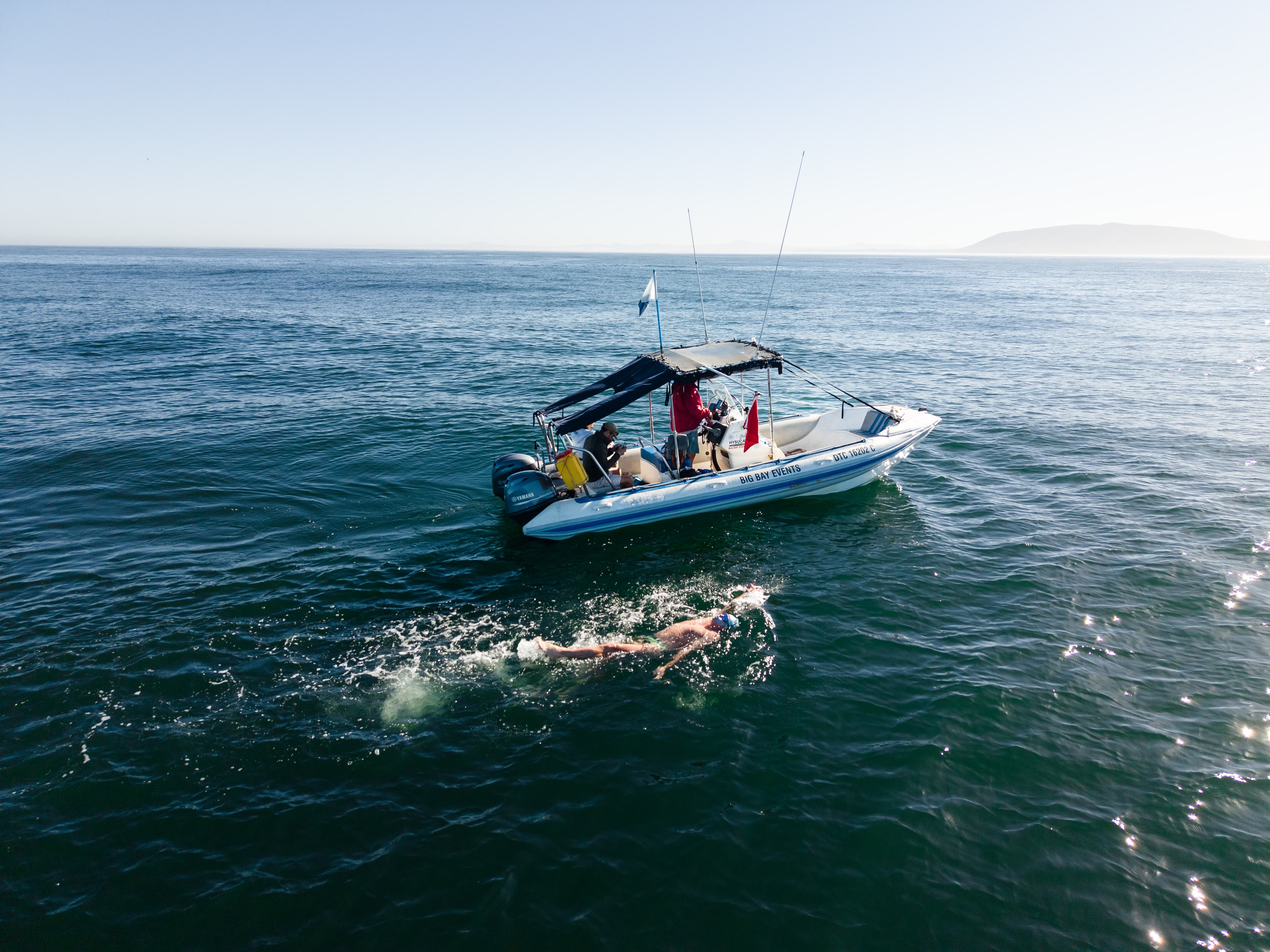 Aerial drone view of boat and swimmer wake, Table Bay