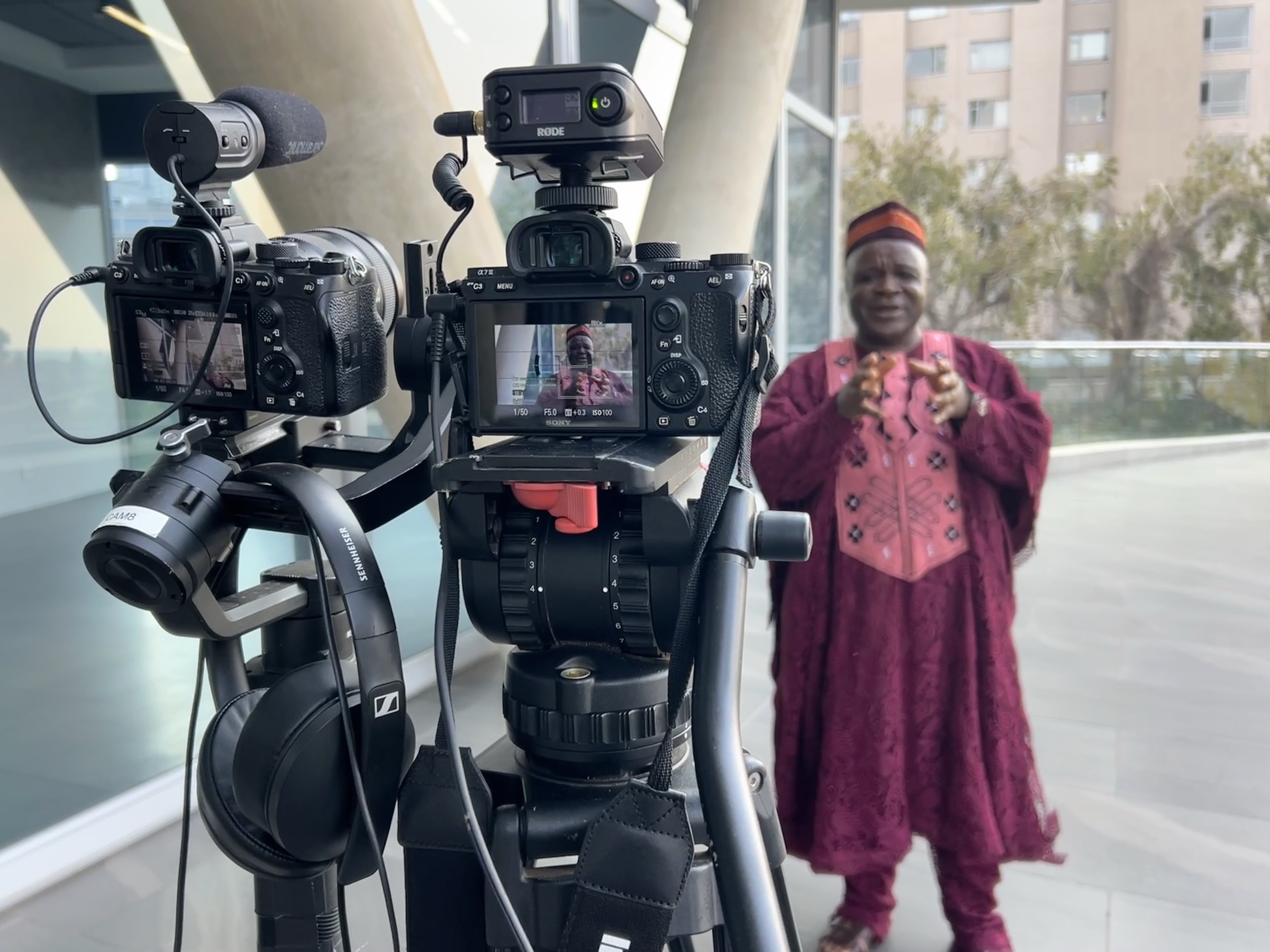 Dual-camera setup filming a corporate interview subject